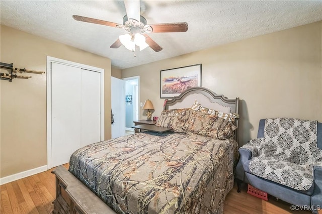 1305 Pea Ridge Rd, King & Queen, VA 23023 - bedroom featuring wood finished floors, a closet, ceiling fan, and a textured ceiling