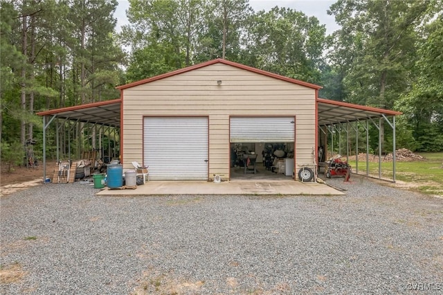 1305 Pea Ridge Rd, King & Queen, VA 23023 - garage featuring a detached garage and view of wooded area