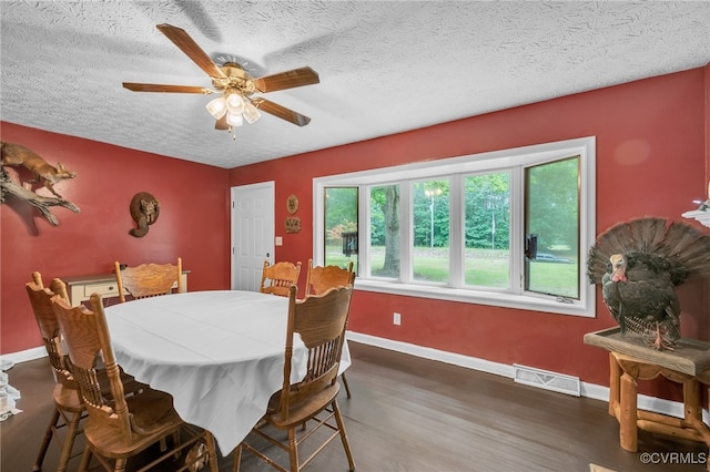 1305 Pea Ridge Rd, King & Queen, VA 23023 - dining area featuring wood finished floors, a textured ceiling, and ceiling fan