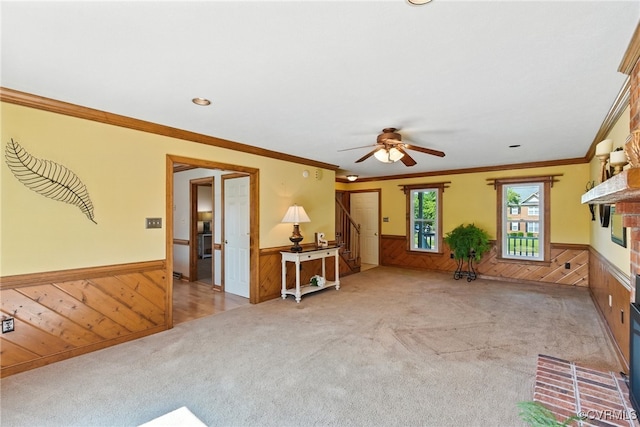8346 Hanover Grove Blvd, Hanover, VA 23111 - carpeted living area with a wainscoted wall, wood walls, ceiling fan, crown molding, and a fireplace