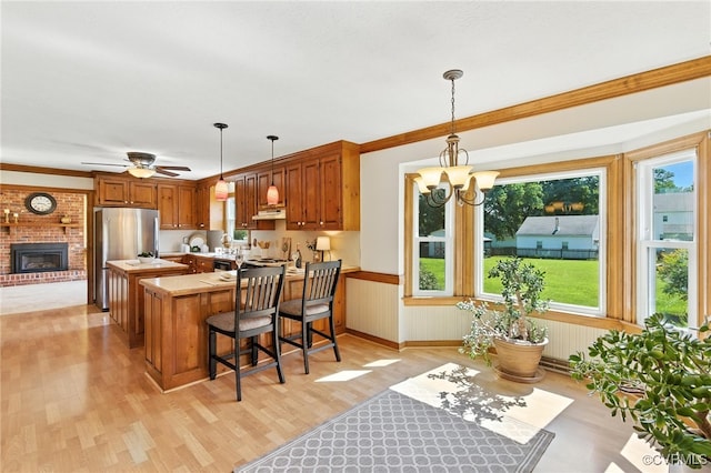 8346 Hanover Grove Blvd, Hanover, VA 23111 - kitchen with light wood-type flooring, light countertops, freestanding refrigerator, a peninsula, and a wainscoted wall