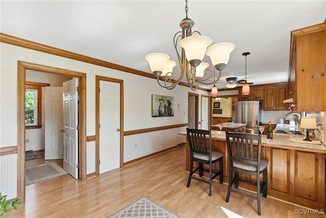 8346 Hanover Grove Blvd, Hanover, VA 23111 - kitchen featuring freestanding refrigerator, a peninsula, light wood-style floors, a wainscoted wall, and light countertops