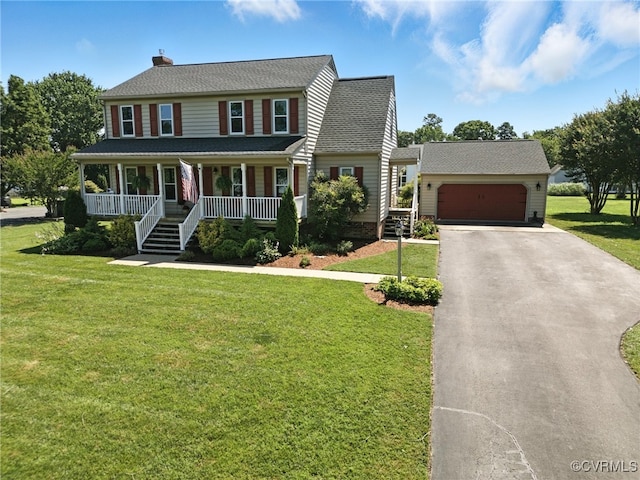 8346 Hanover Grove Blvd, Hanover, VA 23111 - colonial home featuring covered porch, asphalt driveway, a garage, and a front yard