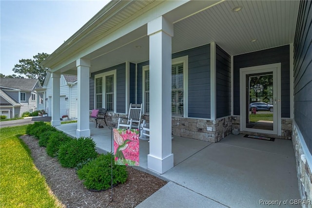 12 Essie Ct, Irvington, VA 22480 - view of exterior entry with a porch and stone siding