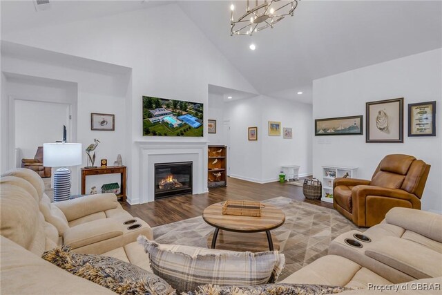 12 Essie Ct, Irvington, VA 22480 - living area with high vaulted ceiling, a glass covered fireplace, wood finished floors, recessed lighting, and a chandelier