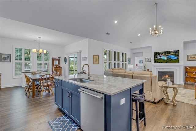 12 Essie Ct, Irvington, VA 22480 - kitchen featuring dishwasher, a chandelier, blue cabinets, a glass covered fireplace, and dark wood finished floors