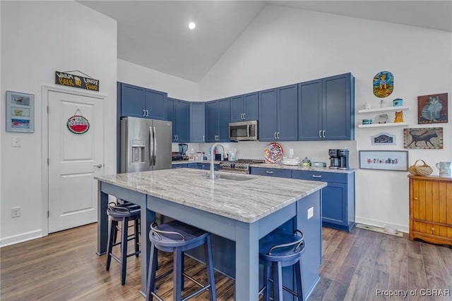 12 Essie Ct, Irvington, VA 22480 - kitchen featuring appliances with stainless steel finishes, blue cabinets, high vaulted ceiling, a kitchen bar, and light stone counters