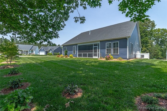 12 Essie Ct, Irvington, VA 22480 - rear view of property with a lawn, a sunroom, and roof with shingles