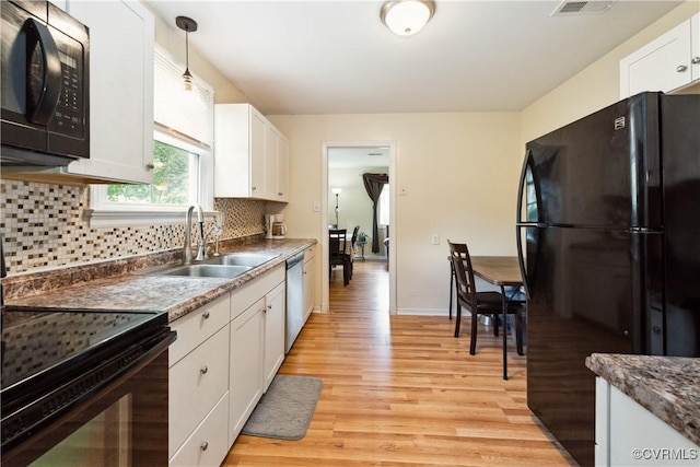 104 N Beech Ave, Henrico, VA 23075 - kitchen with black appliances, light wood-type flooring, white cabinets, and backsplash