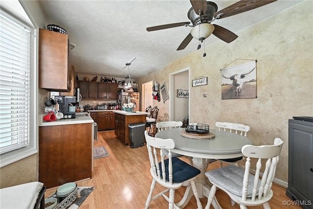 4901 Green Run Dr, Henrico, VA 23228 - dining area with light wood-style flooring, a ceiling fan, and a textured ceiling