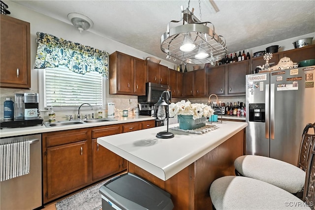 4901 Green Run Dr, Henrico, VA 23228 - kitchen featuring stainless steel appliances, light countertops, tasteful backsplash, a center island, and a textured ceiling