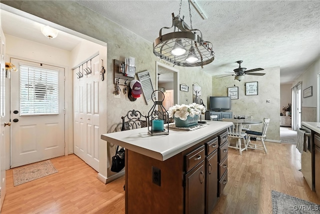 4901 Green Run Dr, Henrico, VA 23228 - kitchen with light wood finished floors, light countertops, a center island, ceiling fan, and a textured ceiling