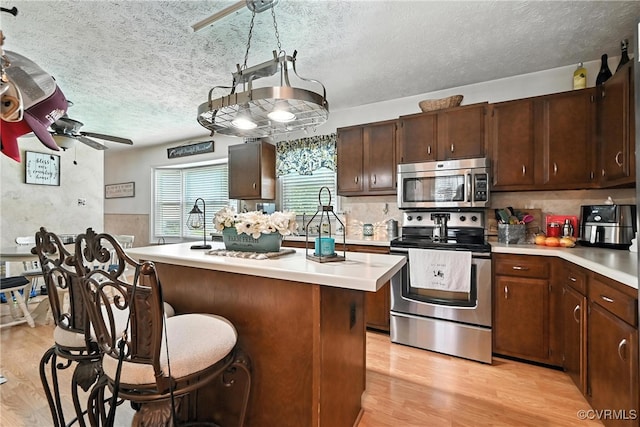4901 Green Run Dr, Henrico, VA 23228 - kitchen featuring stainless steel appliances, a ceiling fan, light wood-type flooring, light countertops, and a textured ceiling