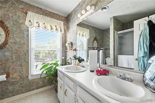 4901 Green Run Dr, Henrico, VA 23228 - bathroom featuring a textured ceiling, double vanity, a stall shower, and tile patterned floors