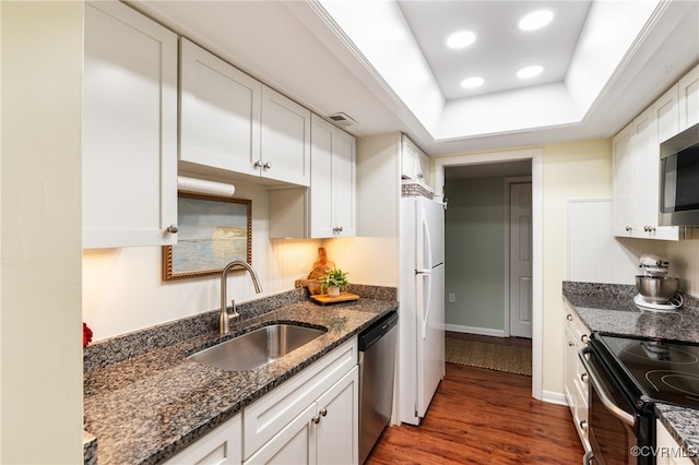 2956 Hathaway Rd Unit 807, Richmond, VA 23225 - kitchen featuring stainless steel appliances, white cabinets, wood finished floors, dark stone counters, and a tray ceiling