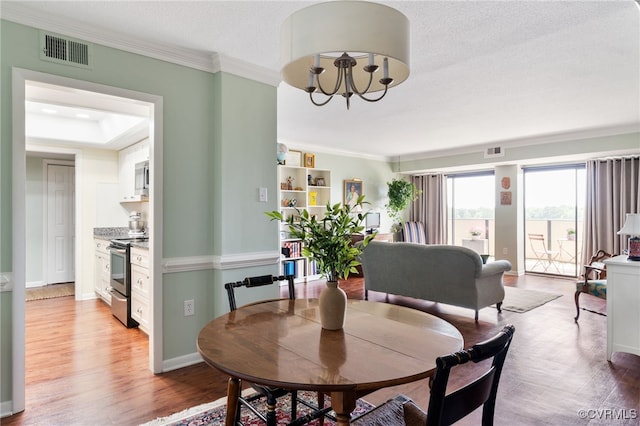 2956 Hathaway Rd Unit 807, Richmond, VA 23225 - dining area featuring ornamental molding, a chandelier, and light wood-style floors