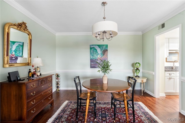 2956 Hathaway Rd Unit 807, Richmond, VA 23225 - dining room featuring wood finished floors, ornamental molding, and a chandelier