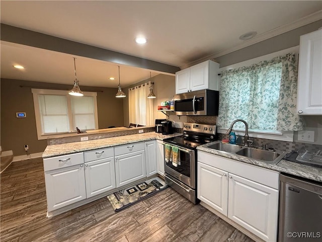 411 Sherman Ave, Hopewell, VA 23860 - kitchen with appliances with stainless steel finishes, a peninsula, dark wood-style flooring, white cabinets, and recessed lighting