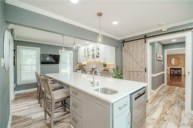1442 Dorset Rd, Powhatan, VA 23139 - kitchen with stainless steel dishwasher, a barn door, light countertops, white cabinetry, and hanging light fixtures