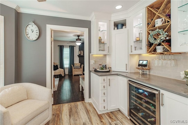 1442 Dorset Rd, Powhatan, VA 23139 - indoor dry bar with beverage cooler, light wood-type flooring, ornamental molding, backsplash, and ceiling fan