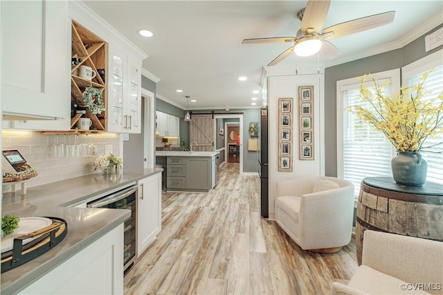1442 Dorset Rd, Powhatan, VA 23139 - kitchen with a barn door, crown molding, beverage cooler, backsplash, and ceiling fan