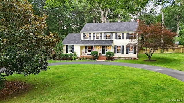 2711 Salisbury Rd, Midlothian, VA 23113 - colonial house with a porch, roof with shingles, a chimney, asphalt driveway, and view of wooded area