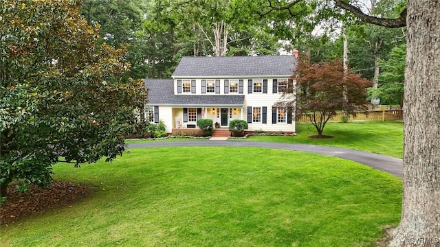 2711 Salisbury Rd, Midlothian, VA 23113 - colonial home featuring asphalt driveway, a chimney, a shingled roof, and covered porch
