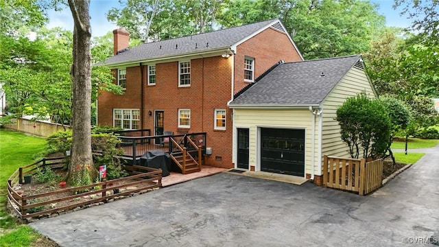 2711 Salisbury Rd, Midlothian, VA 23113 - rear view of house featuring a chimney, a deck, brick siding, an attached garage, and asphalt driveway