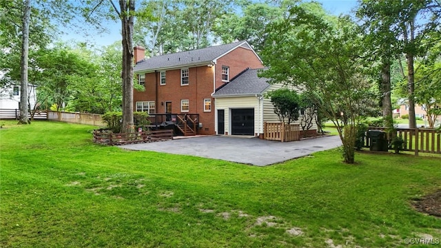 2711 Salisbury Rd, Midlothian, VA 23113 - rear view of property featuring a chimney, brick siding, a garage, stairs, and a wooden deck