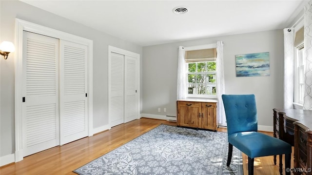 2711 Salisbury Rd, Midlothian, VA 23113 - living area with light wood-style flooring and a baseboard radiator