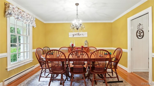 2711 Salisbury Rd, Midlothian, VA 23113 - dining space with a baseboard radiator, healthy amount of natural light, wood finished floors, crown molding, and a chandelier