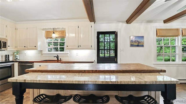 2711 Salisbury Rd, Midlothian, VA 23113 - kitchen featuring stainless steel appliances, plenty of natural light, decorative backsplash, beam ceiling, and a center island