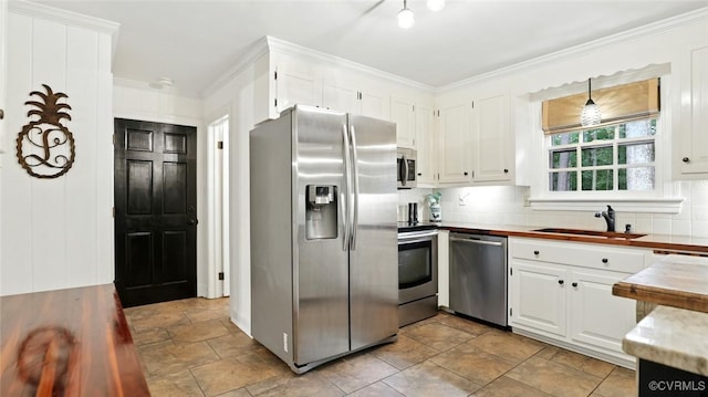 2711 Salisbury Rd, Midlothian, VA 23113 - kitchen featuring stainless steel appliances, stone finish floors, white cabinetry, tasteful backsplash, and ornamental molding