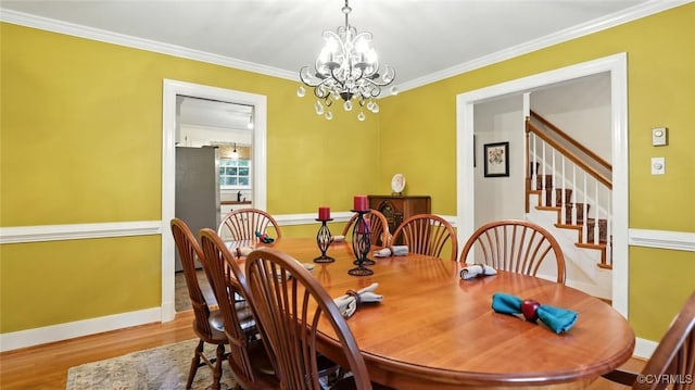 2711 Salisbury Rd, Midlothian, VA 23113 - dining room with a chandelier, wood finished floors, ornamental molding, and stairway