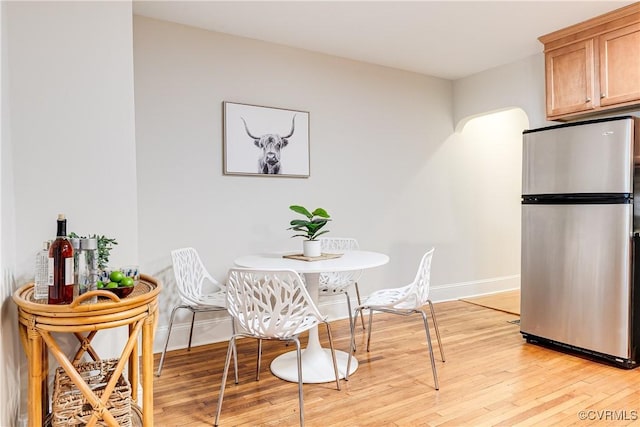 619 Roseneath Rd Unit U21, Richmond, VA 23221 - dining area with light wood-type flooring and arched walkways