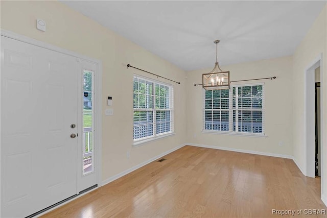 8619 Thomas Jefferson Way, Gloucester, VA 23061 - foyer with light wood finished floors and a chandelier