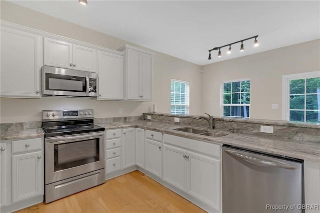 8619 Thomas Jefferson Way, Gloucester, VA 23061 - kitchen featuring appliances with stainless steel finishes, rail lighting, white cabinets, and light wood-style flooring