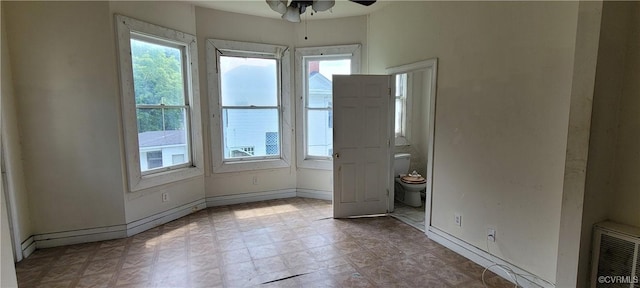 22 Corling St, Petersburg, VA 23803 - empty room with ceiling fan and healthy amount of natural light