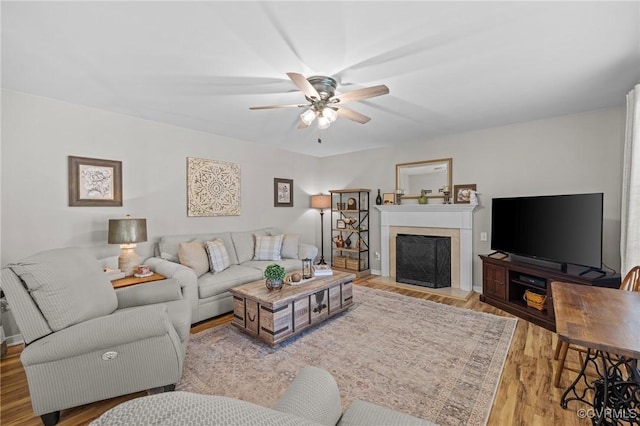 11830 Explorer Ct, Midlothian, VA 23114 - living room featuring a ceiling fan, wood finished floors, and a fireplace with raised hearth