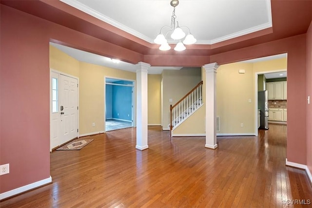 8738 New Holland Ln, Mechanicsville, VA 23116 - entryway with ornate columns, hardwood / wood-style floors, stairway, a chandelier, and ornamental molding