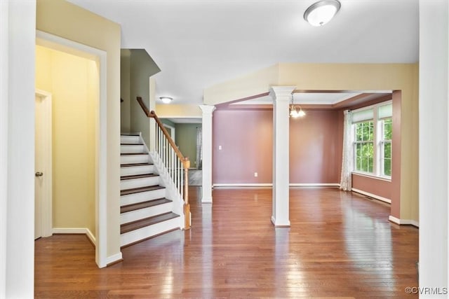8738 New Holland Ln, Mechanicsville, VA 23116 - unfurnished living room featuring decorative columns, hardwood / wood-style flooring, and stairs