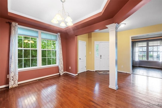 8738 New Holland Ln, Mechanicsville, VA 23116 - unfurnished room featuring decorative columns, a raised ceiling, a chandelier, wood-type flooring, and crown molding