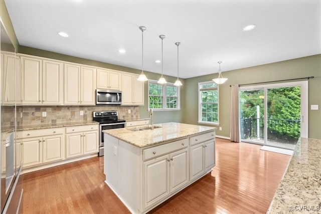 8738 New Holland Ln, Mechanicsville, VA 23116 - kitchen with stainless steel appliances, light wood-style floors, tasteful backsplash, light stone countertops, and recessed lighting
