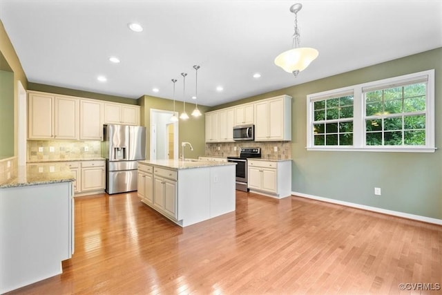8738 New Holland Ln, Mechanicsville, VA 23116 - kitchen featuring appliances with stainless steel finishes, decorative backsplash, light wood-style floors, pendant lighting, and recessed lighting