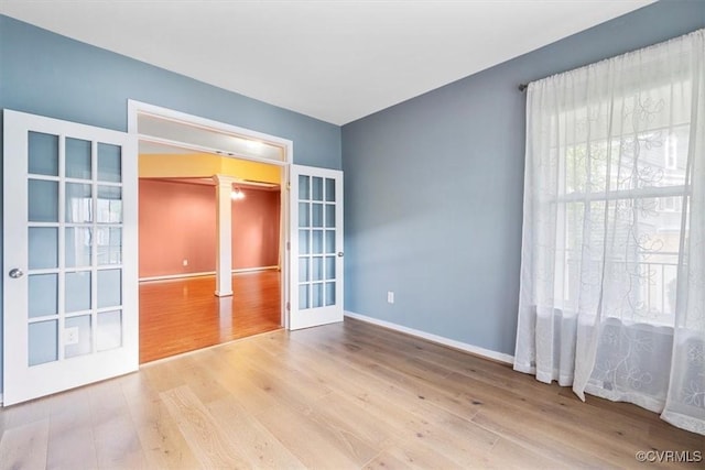 8738 New Holland Ln, Mechanicsville, VA 23116 - empty room with french doors, ornate columns, and wood finished floors