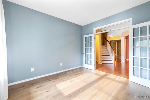 8738 New Holland Ln, Mechanicsville, VA 23116 - unfurnished room with wood finished floors, french doors, stairs, and decorative columns