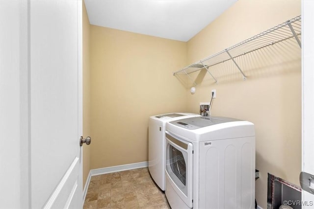 8738 New Holland Ln, Mechanicsville, VA 23116 - laundry area with washing machine and clothes dryer and stone finish flooring
