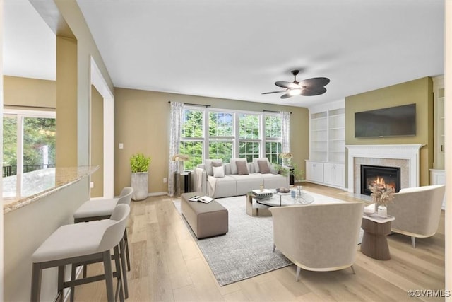 8738 New Holland Ln, Mechanicsville, VA 23116 - living area featuring ceiling fan, plenty of natural light, light wood-style floors, and a fireplace with flush hearth