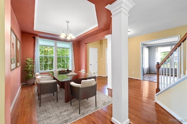 8738 New Holland Ln, Mechanicsville, VA 23116 - dining area featuring ornate columns, a chandelier, wood finished floors, and plenty of natural light