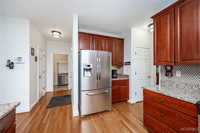 5020 Park Meadows Way, Glen Allen, VA 23059 - kitchen with stainless steel fridge, light wood-style floors, tasteful backsplash, and light stone counters